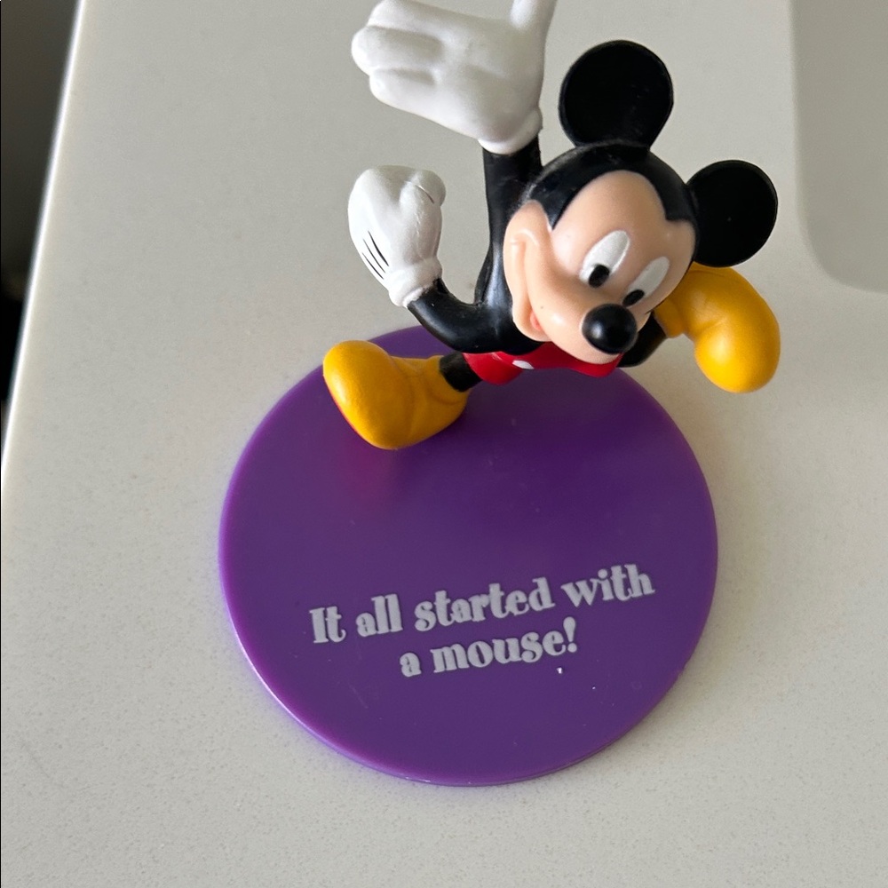 Disney Mickey Mouse Figure with Red Shorts and Yellow Shoes on Purple Stand